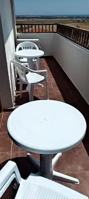 a white table and chairs on a balcony at Vineyard Spa Resort 2-Room Apartement in Kableshkovo