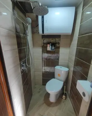 a small bathroom with a toilet and a shower at Tiny House in the center of Varna in Varna City
