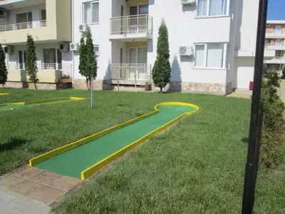 a yellow and green golf course in a yard at 2 kamer appartement Nessebar Fort Club Sunny Beach in Sunny Beach