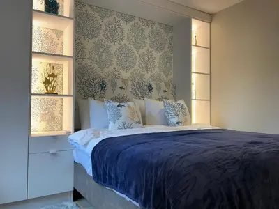 a bedroom with a bed with a blue comforter at Apartment Ivan in Pomorie