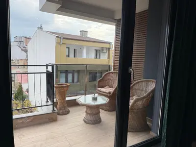 a balcony with chairs and a table on a balcony at Tea'S Apartment in Varna City