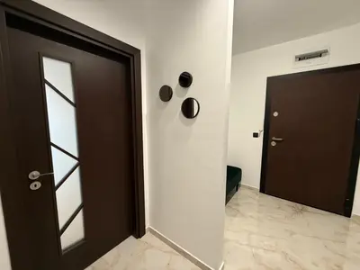 a black door in a white room with a doorway at Tea'S Apartment in Varna City