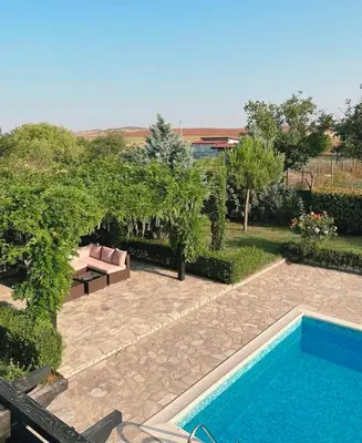 a backyard with a swimming pool and a garden at Garden Villa 2 Bedroom Villa with pool near to Sunny beach in Aleksandrovo