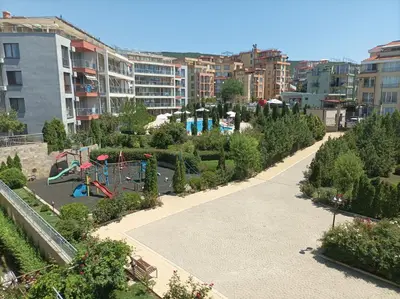 a park with a playground in a city at Sun Wave Apartment near the Sea in Sveti Vlas