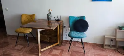 two chairs and a wooden table with a desk at Sun Wave Apartment near the Sea in Sveti Vlas