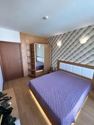 a bedroom with a purple bed in a room at Sea Home 1 in Sunny Beach