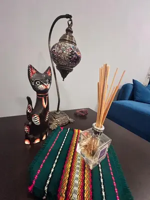 a table with a lamp and a black cat on it at Sea Home in Sunny Beach