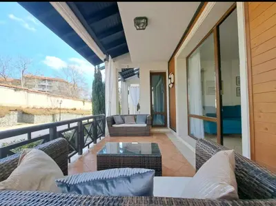 a balcony with a couch and a table and chairs at Top Oasis Park Lozenets apartment in Lozenets