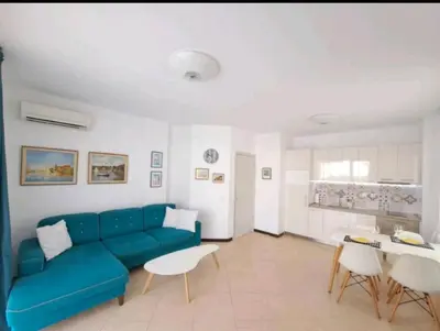 a living room with a blue couch and a table at Top Oasis Park Lozenets apartment in Lozenets