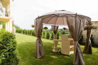 an umbrella in a yard with a lawn at Villa SeaBreeze in Varna City
