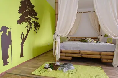 a bedroom with a bed with a tree on the wall at Villa SeaBreeze in Varna City
