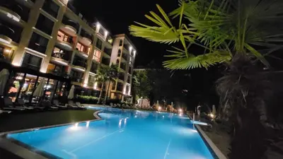 a large swimming pool at night with buildings at Palma Beach in Harmony Suites 2,3 in Sunny Beach