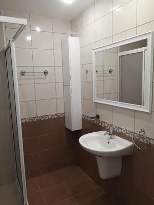 a bathroom with a sink and a mirror at South Beach Apartment in Nesebar