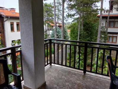 a balcony with a black railing and trees at Трёхкомнатные роскошные апартаменты у моря в Санта Марина in Sozopol