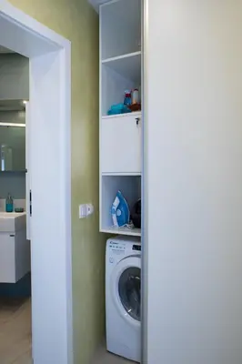 a laundry room with a washing machine in a room at Sea Bliss in Burgas City