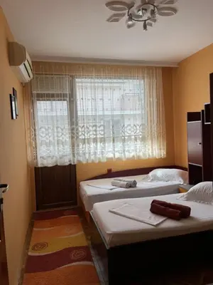 two twin beds in a room with a window at Apartment Geni in Pomorie