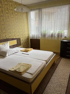 a bedroom with a bed with two towels on it at Apartment Geni in Pomorie