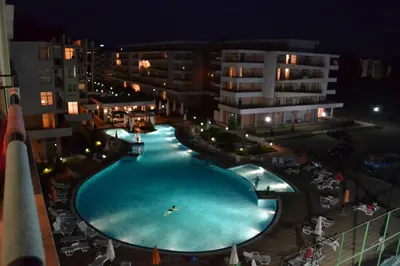 an overhead view of a swimming pool at night at Grand Kamelia Apartment in Sunny Beach