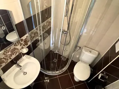 a bathroom with a shower and a toilet and a sink at Stamopolu Lux ground floor in Primorsko