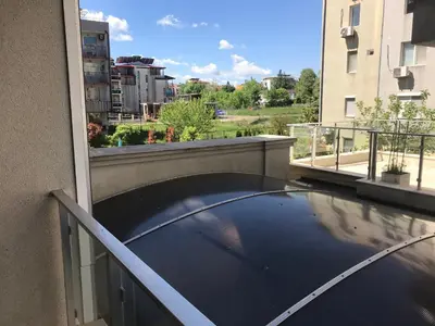a balcony with a view of a building at Stamopolu Lux ground floor in Primorsko