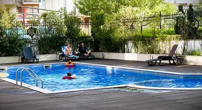 a group of people swimming in a swimming pool at Stamopolu Lux ground floor in Primorsko