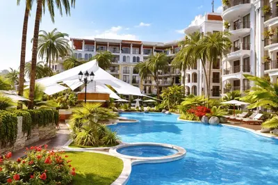 a resort swimming pool with palm trees and buildings at Harmony Suites-1 Private Apartment 42А in Sunny Beach