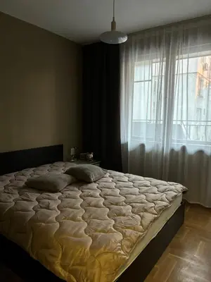 a large bed in a bedroom with a window at Апартамент 8 in Varna City