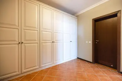 a room with white cabinets and a door at LUXURY APARTMENT Sozopolis in Sozopol