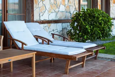 two chairs with cushions sitting on a patio at LUXURY APARTMENT Sozopolis in Sozopol