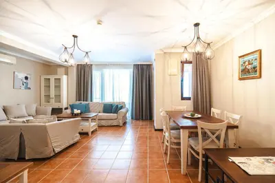 a living room with a couch and a table at LUXURY APARTMENT Sozopolis in Sozopol