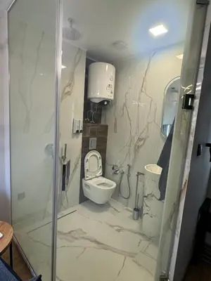a bathroom with a toilet and a sink at Room de Port in Burgas City
