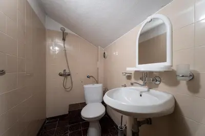 a bathroom with a sink and a toilet and a mirror at Citybox - Shipka in Varna City