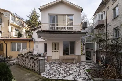a white house with a balcony and a patio at Citybox - Shipka in Varna City