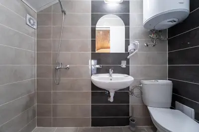 a bathroom with a toilet and a sink at Citybox - Shipka in Varna City