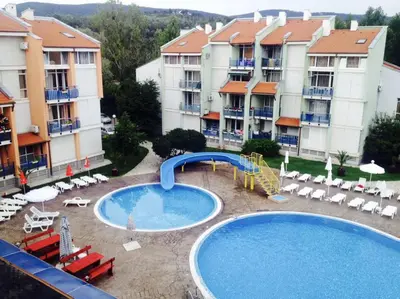 a swimming pool with a slide in front of some apartment buildings at Spacious Modern Two-Bedroon Suite in Elit 1 Complex in Sunny Beach