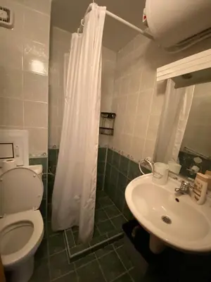 a bathroom with a toilet and a sink at Spacious Modern Two-Bedroon Suite in Elit 1 Complex in Sunny Beach