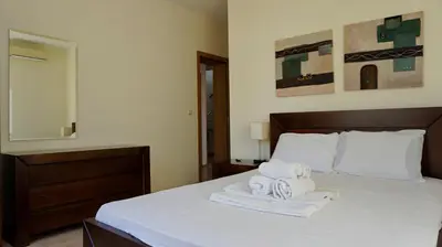 a bedroom with a bed with two towels on it at вила Мариела - villa Mariela in Yunets
