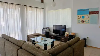 a living room with a couch and a tv at вила Мариела - villa Mariela in Yunets