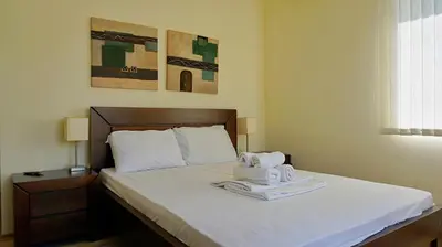 a bedroom with a bed with two towels on it at вила Мариела - villa Mariela in Yunets