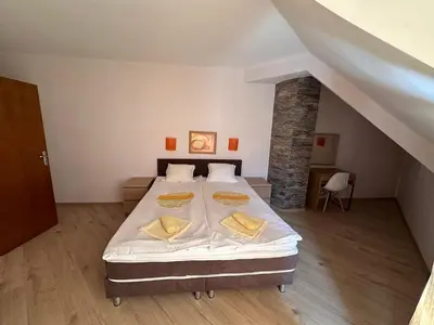 a bedroom with a bed with white sheets and yellow pillows at Hotel Energy in Kiten