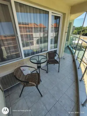 a balcony with a glass table and chairs on it at Family Hotel Coral in Sozopol