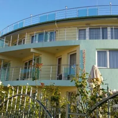a building with a balcony on top of it at Family Hotel Coral in Sozopol