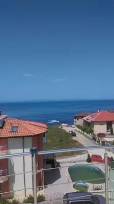 a view of the ocean from the balcony of a house at Family Hotel Coral in Sozopol