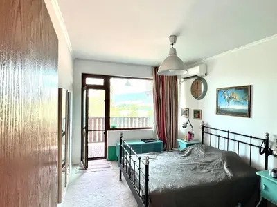 a bedroom with a bed and a balcony at Arkutino Beach in Burgas City
