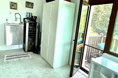 a kitchen with a white refrigerator next to a balcony at Arkutino Beach in Burgas City