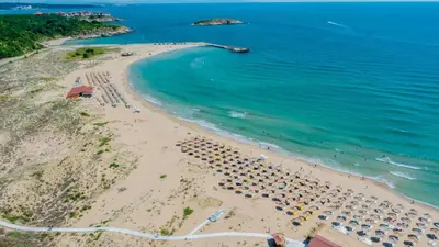 an aerial view of a beach with umbrellas and the ocean at Arkutino Beach in Burgas City