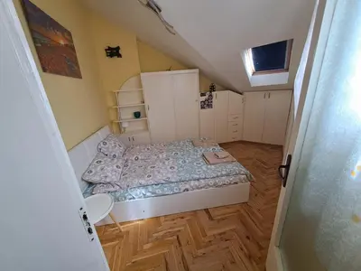 a small bedroom with a bed and cabinets in it at Varna city breaks 1 in Varna City