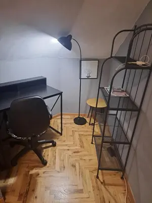a desk and a chair in a room with a desk and bunk beds at Varna city breaks 1 in Varna City