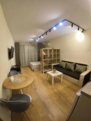 a living room with a couch and a table at Salt Lake Studio in Pomorie