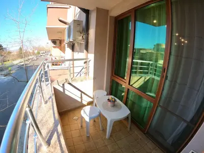 a balcony with a table and chairs on a balcony at Salt Lake Studio in Pomorie